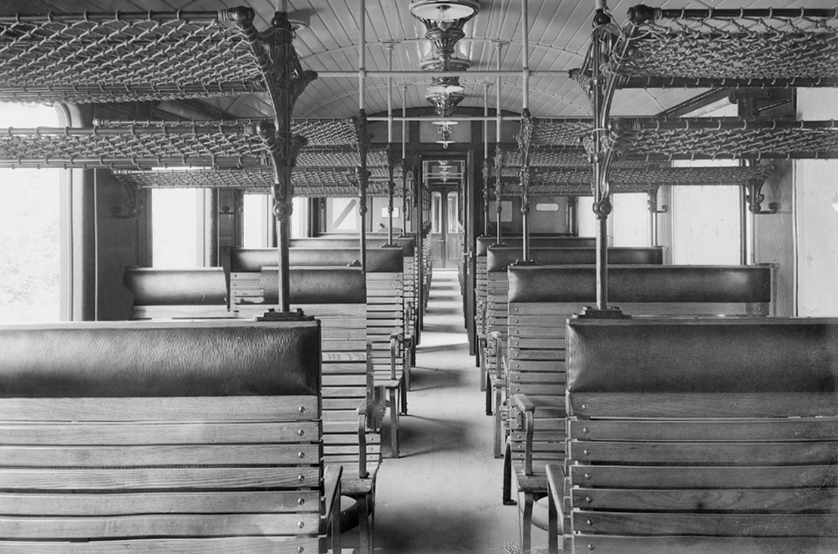 An old train compartment in black and white, symbolic of image editing - n c ag