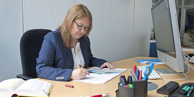 Chantal Weyermann correcting a text at her desk - n c ag