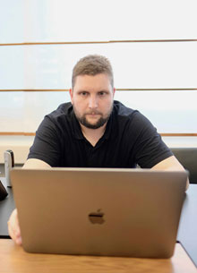 Manuel Ginesta sits at the computer and works as an application developer - n c ag