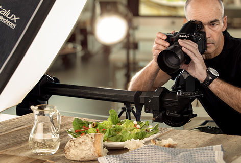 A photographer taking a food shot in the studio, symbolic of mood images - n c ag