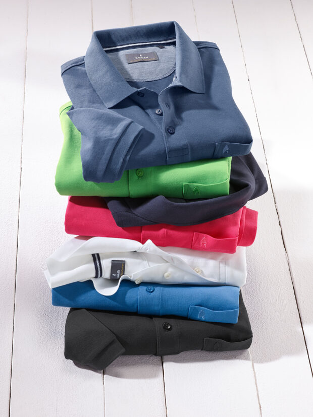 Image of a stack of different polo shirts, symbolic of photography - n c ag